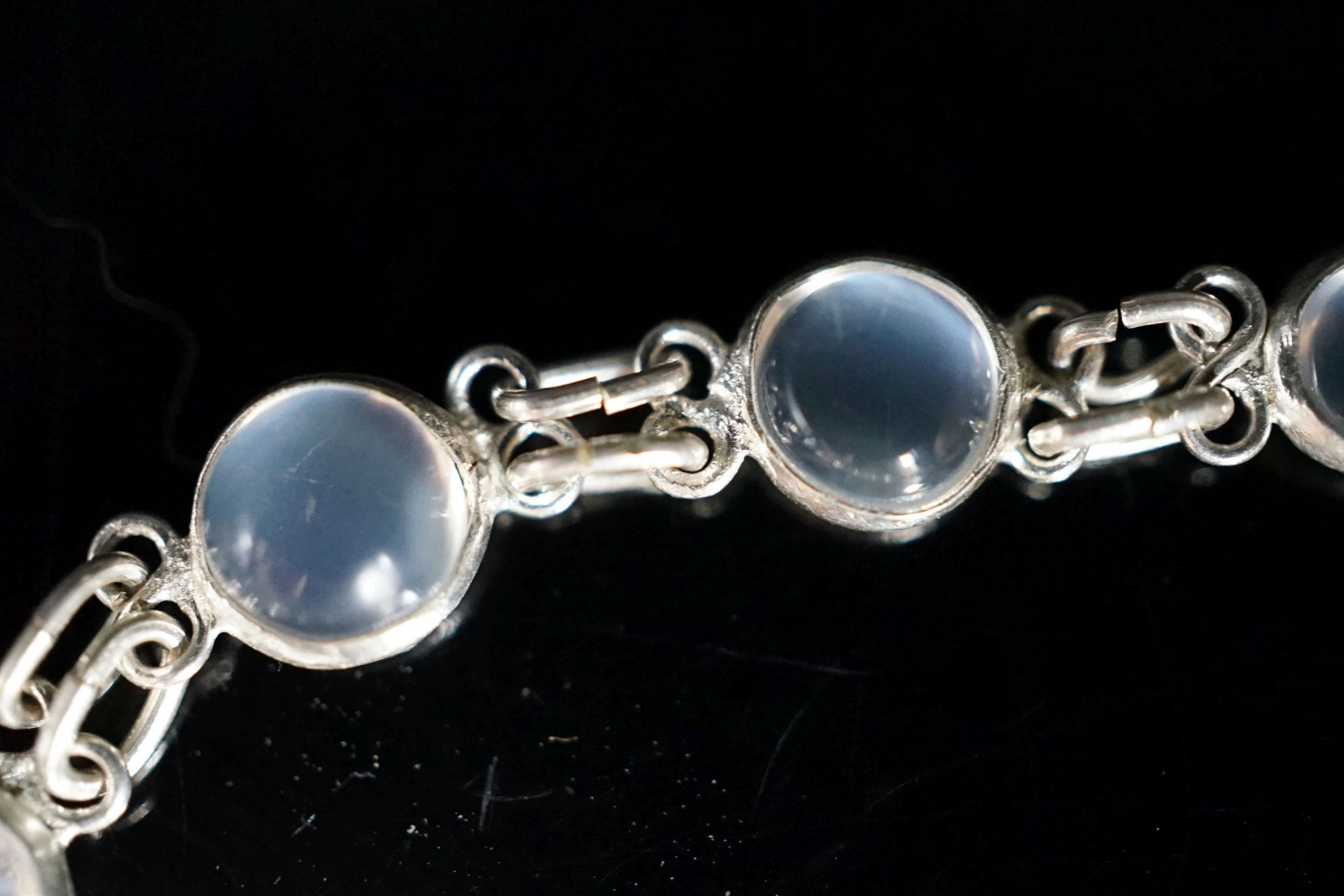 A modern (1980's) white metal and graduated moonstone set bracelet, 17cm.